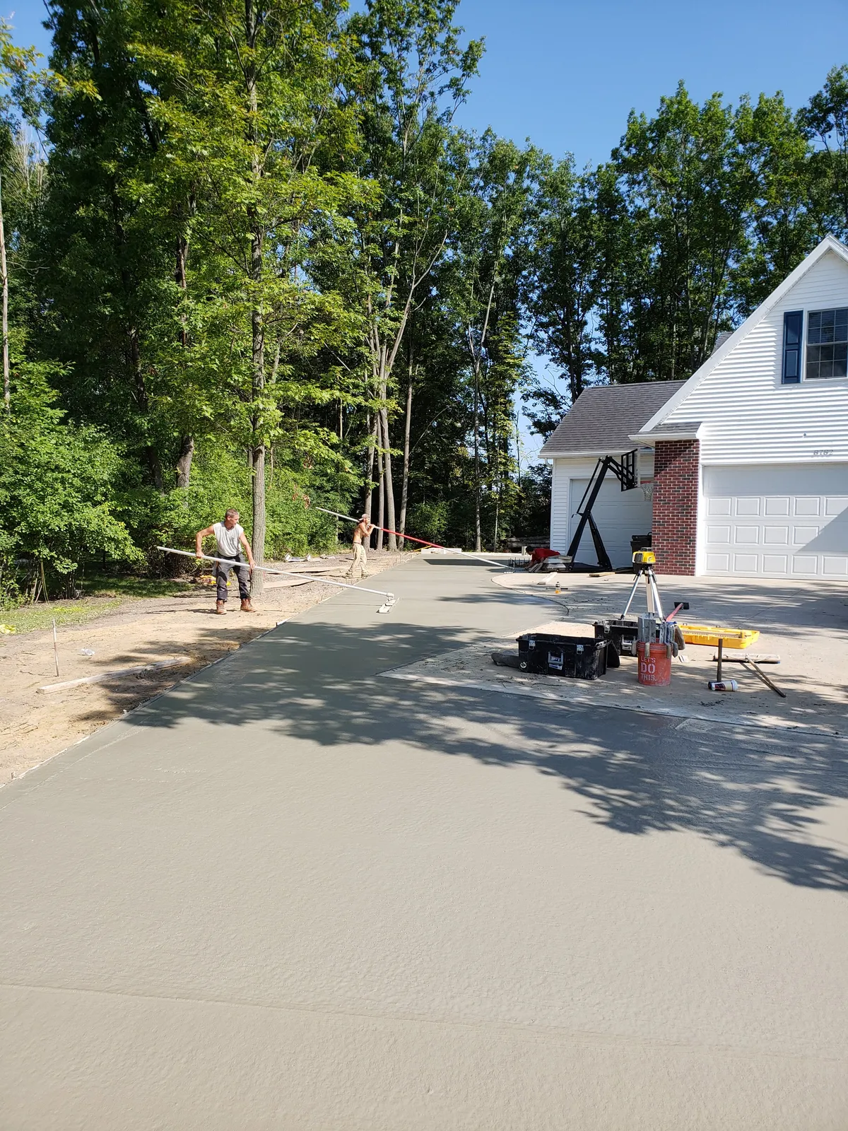 Wide concrete driveway approach leading to a two-car garage in Mid-Michigan