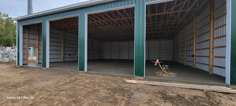 Multi-bay concrete floor finished inside a large pole barn